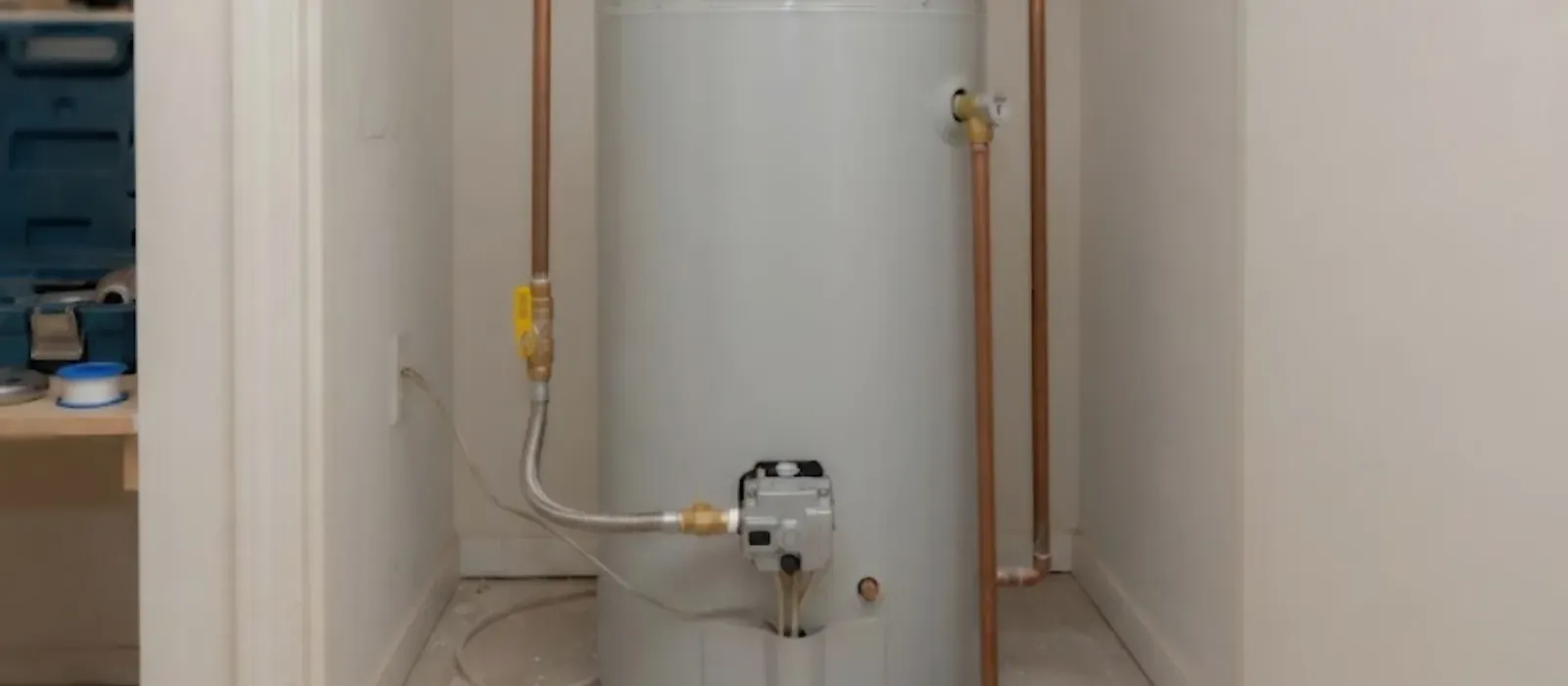 Tank water heater in a utility closet with copper supply pipes